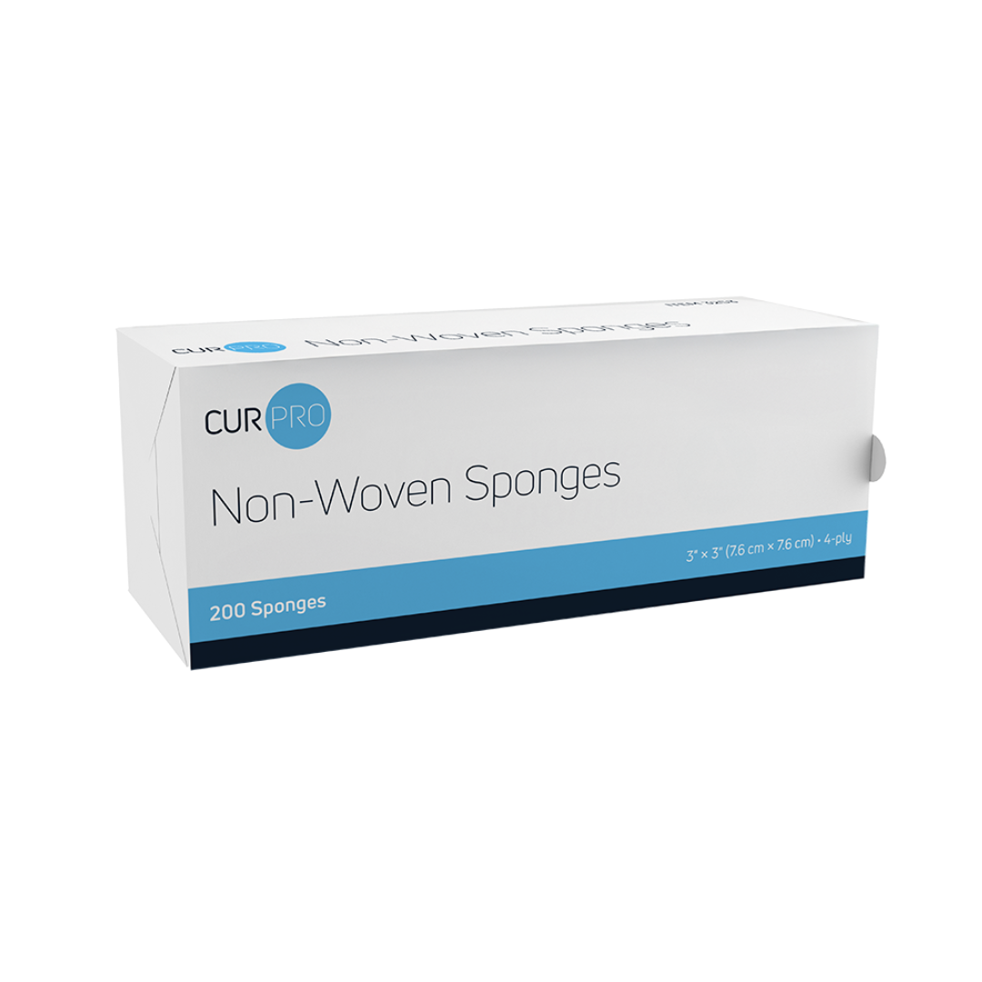 A rectangular white and blue box labeled Dynarex CurPro Non-Woven Sponges contains 200 premium-quality, highly absorbent 4-ply sponges (3 x 3 in/7.6 x 7.6 cm). The box features a blue band near the bottom and branding on the top left.